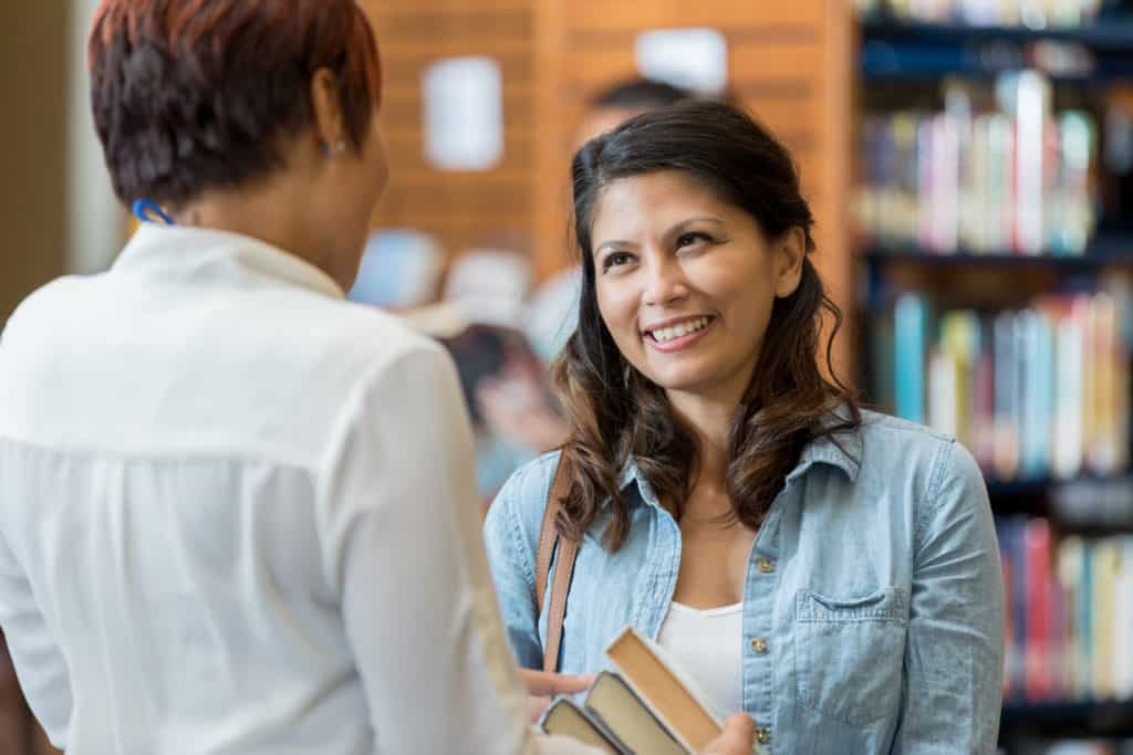 Librarian helps female college student