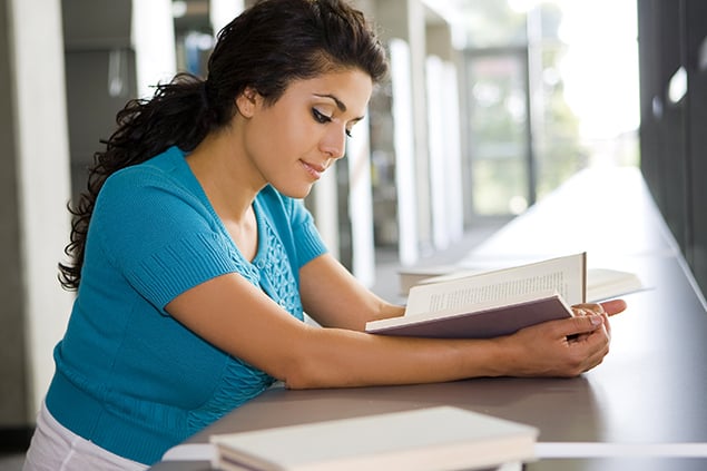 A Latin American student studying for exams