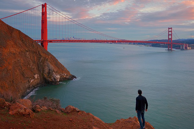 A Man is Looking at Golden Gate Bridge, California, USA