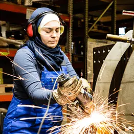 Woman in safety gear welding