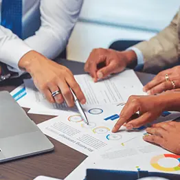 Business people pointing at paperwork