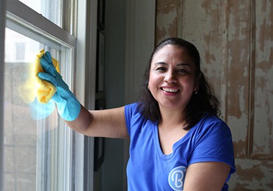 Woman cleaning window