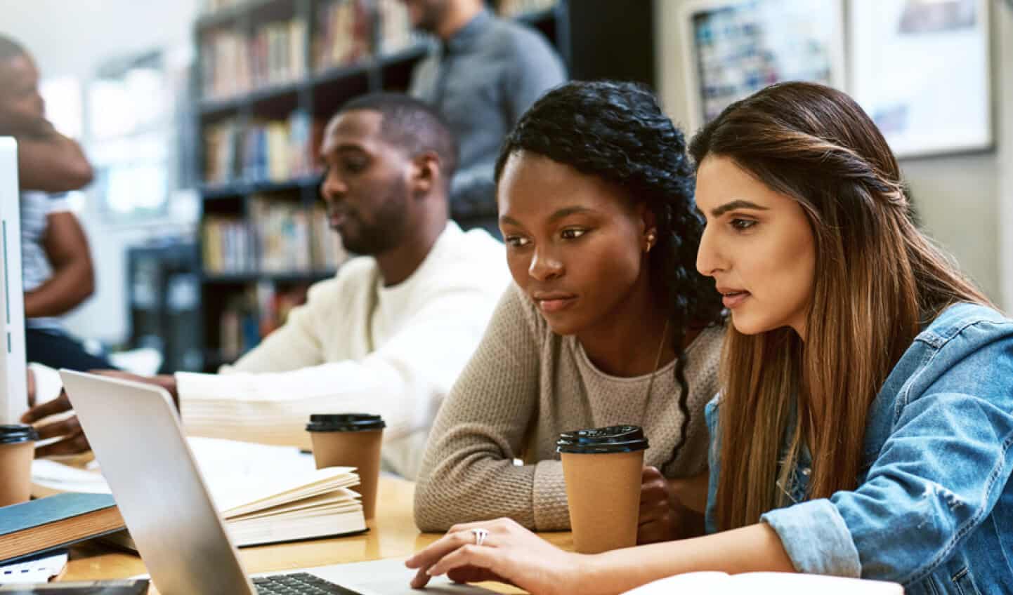 Students looking at laptop