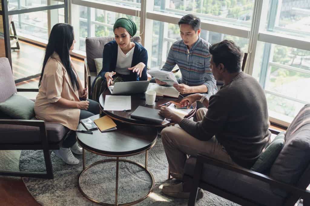 Group of adults discussing around a table