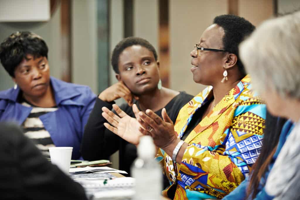 Immigrant women discussing at table