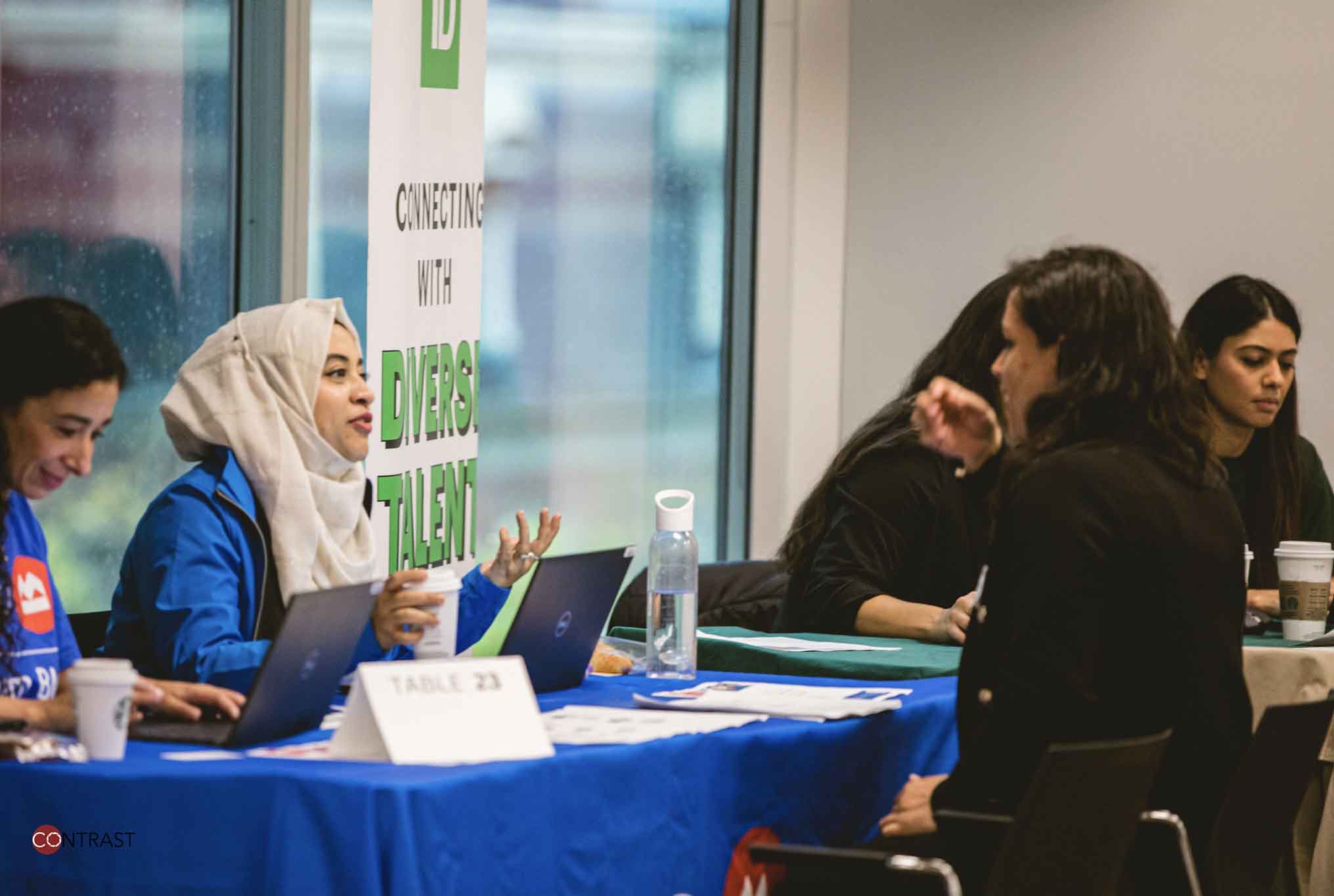 Women speaking to each other at an Expo