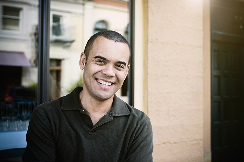 Young man smiling in front of office