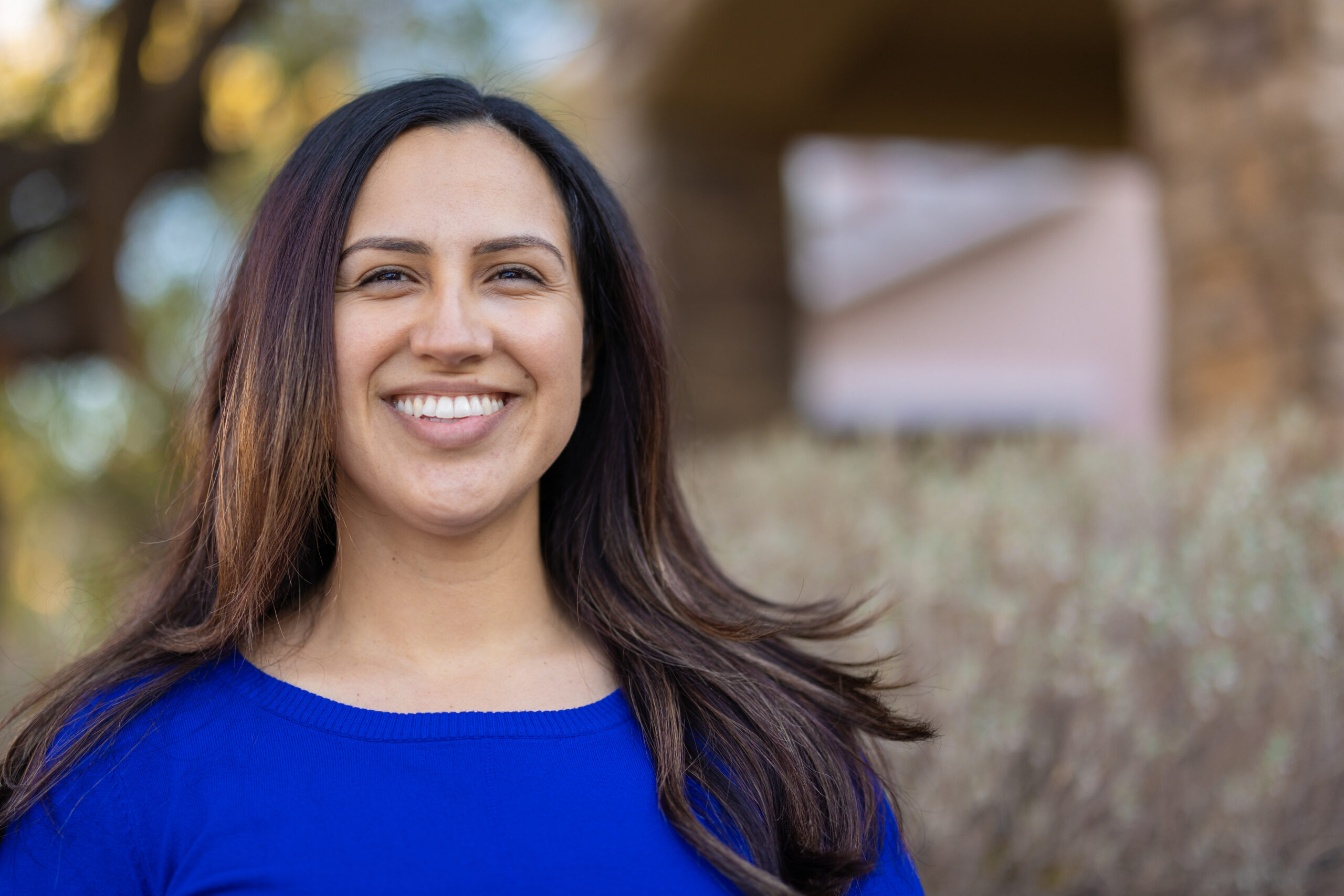 A testimonial portrait of a Hispanic woman.