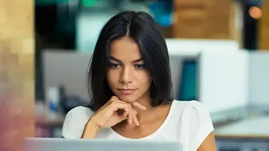 young woman studying laptop screen