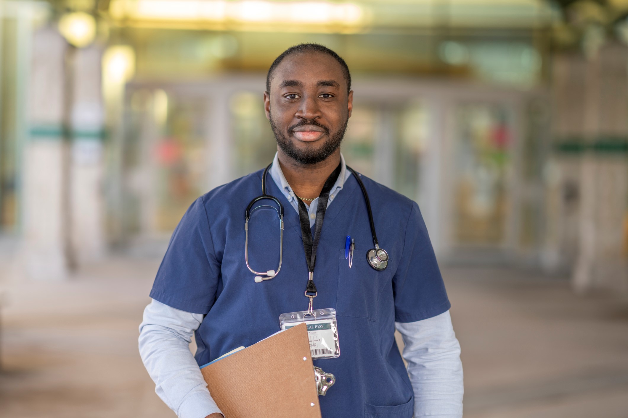 Black doctor standing outside hospital