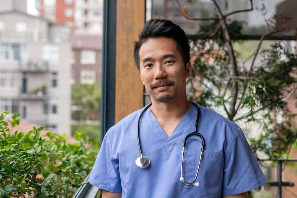 Male doctor smiling at camera (occupational licensure blog image)